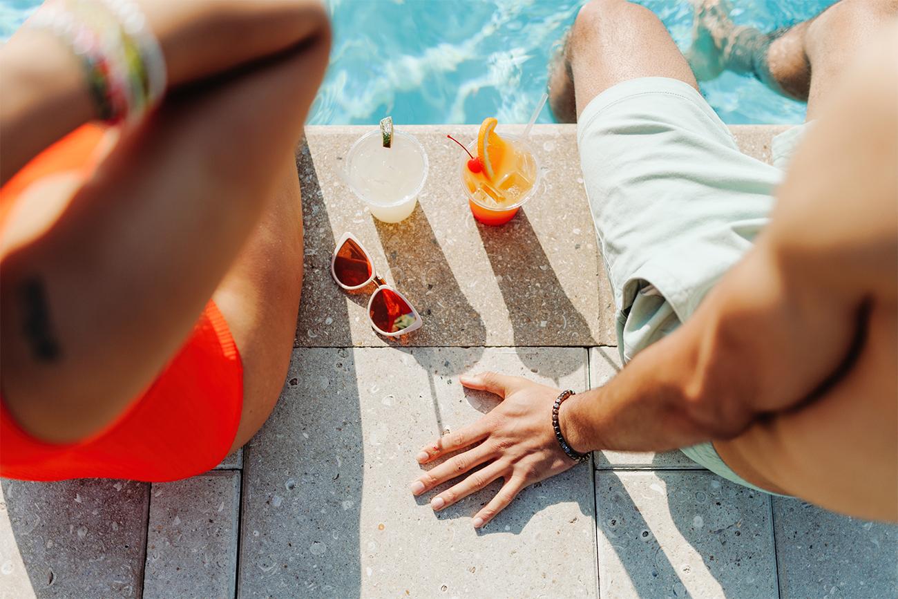 Couple with drinks by the pool