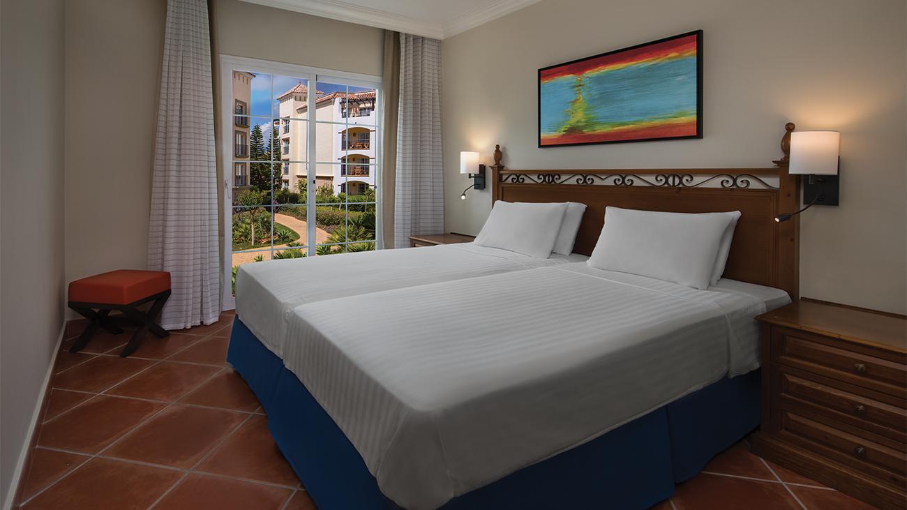 py-two-bedroom-garden-view-guest-bedroom-interior-photo