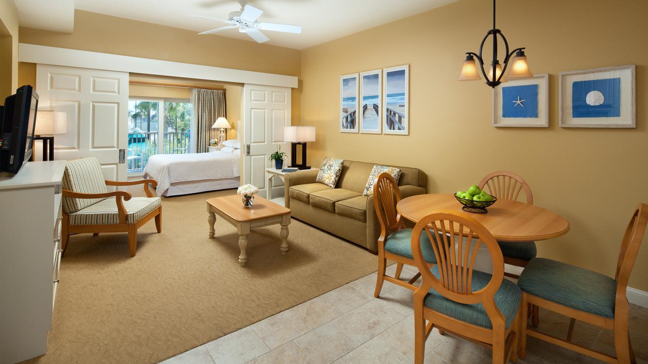 sbp-palmetto-two-bedroom-lockoff-one-bedroom-bedroom-and-living-room-interior-photo