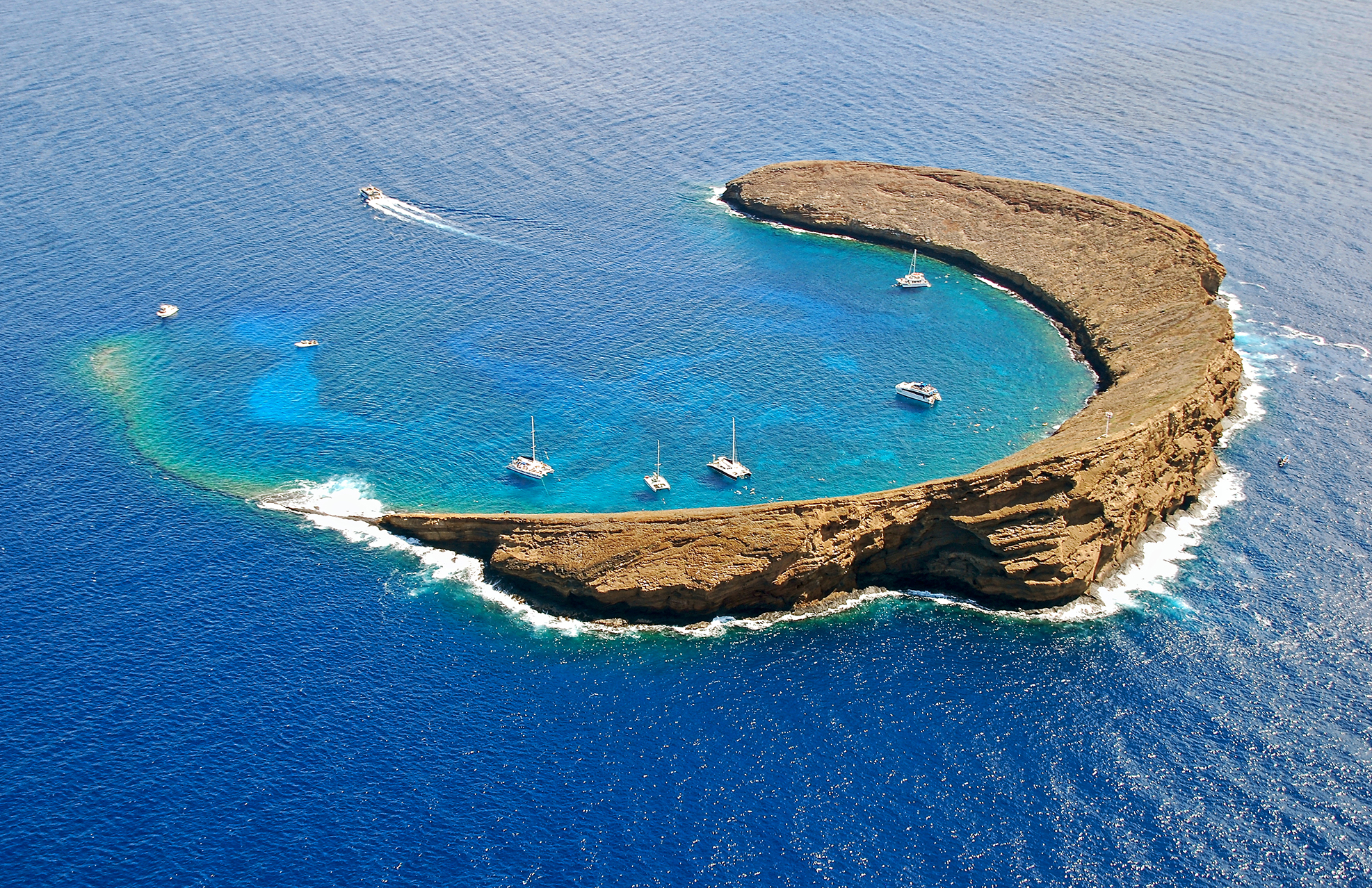 Divers and snorkelers in the water at Molokini a dormant volcanic crater