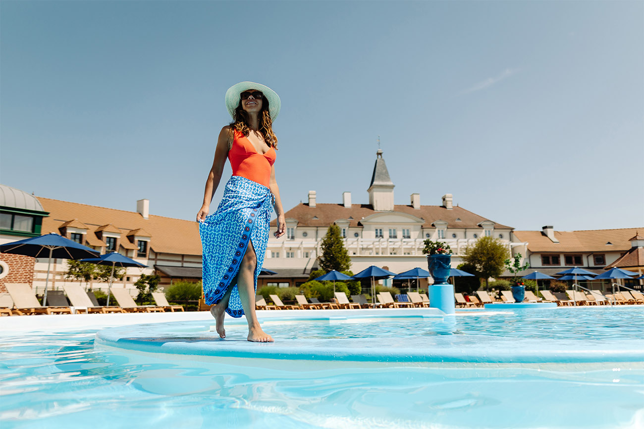 A woman walking in the pool at Marriott's Village d'Ile-de-France