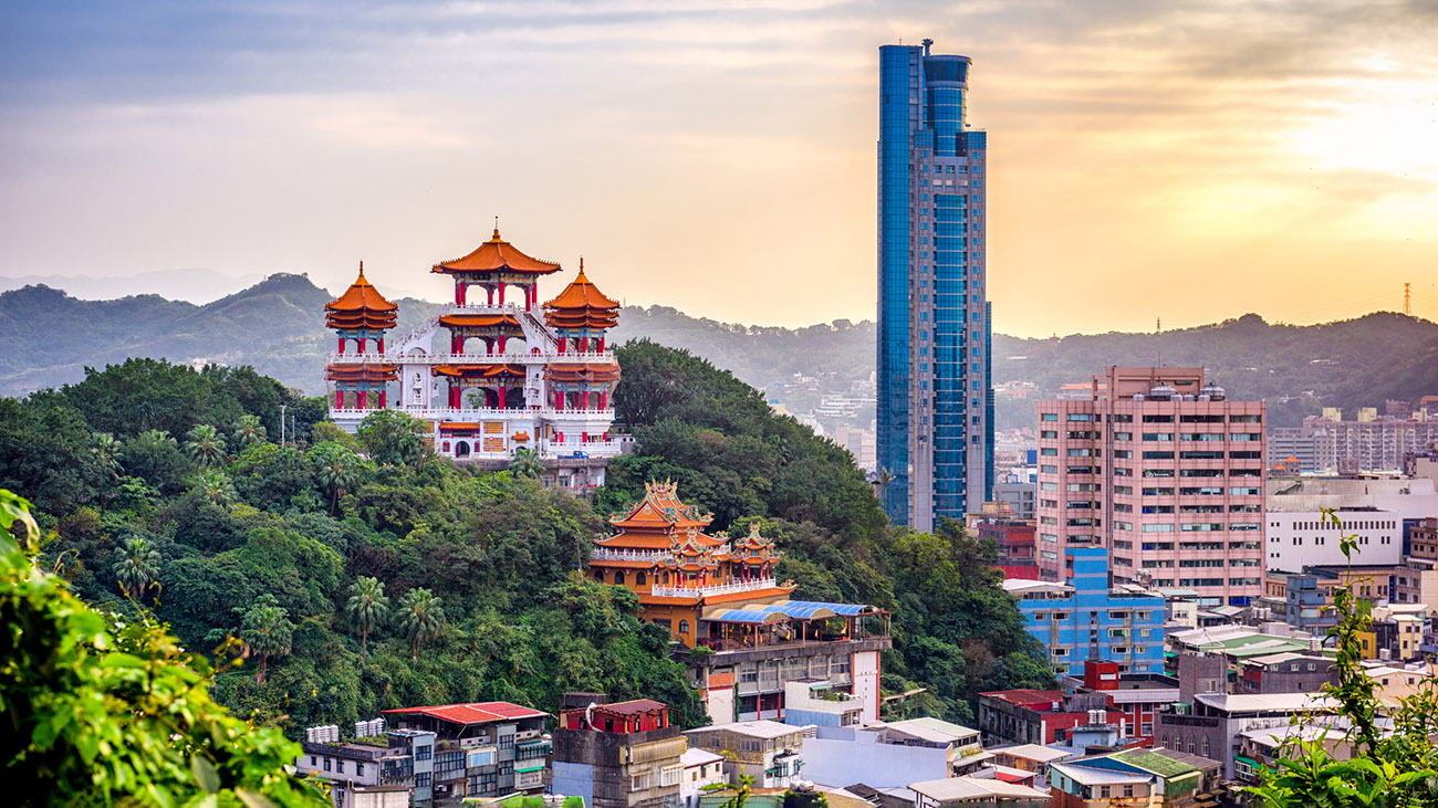 Cityscape of Keelung, Taipei, with a tall modern building and mixed traditional architecture.