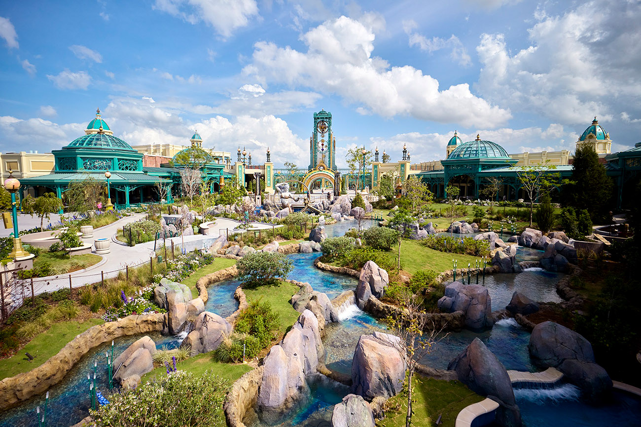 Wide view of Celestial Park at Universal with landscaped greenery, pathways, and modern architectural features.