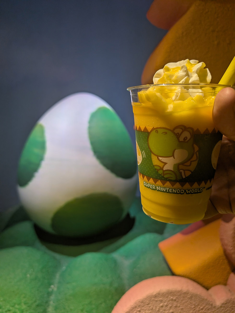 Yoshi-themed area with a green Yoshi figure, colorful decorations, and a themed backdrop.