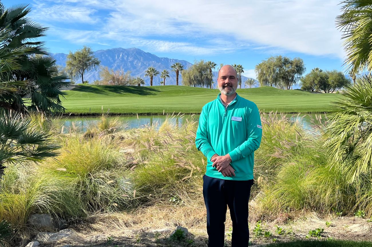 The bright greens of a golf course are lit by the sun in front of Marriott’s Shadow Ridge resort.