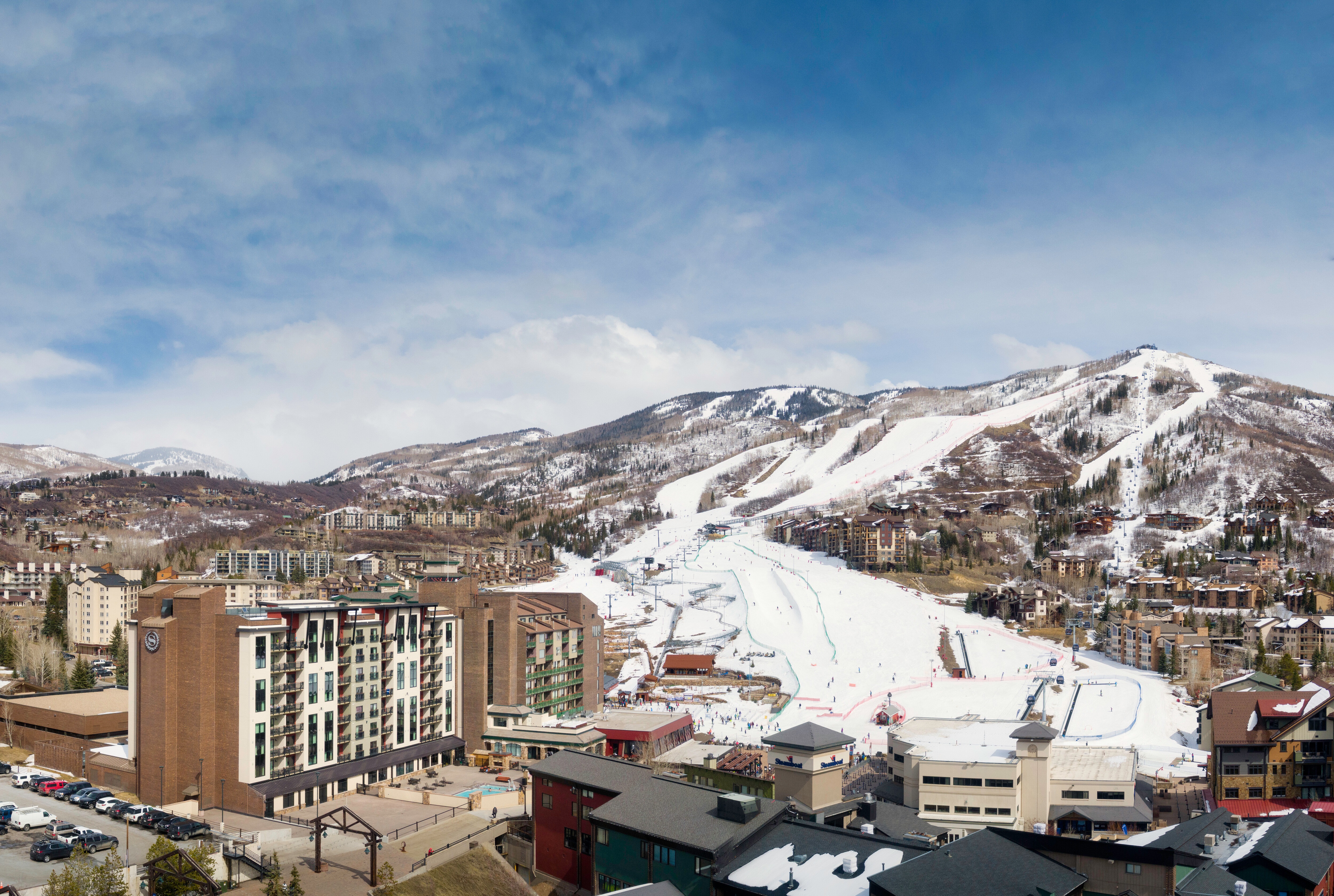 A mountain ski resort with snow-covered slopes.   