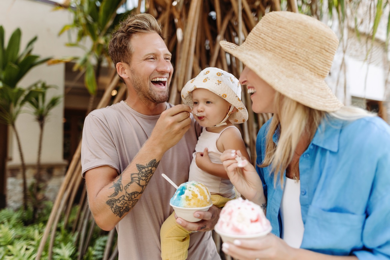 A family enjoys a cold Hawaiian treat outdoors.