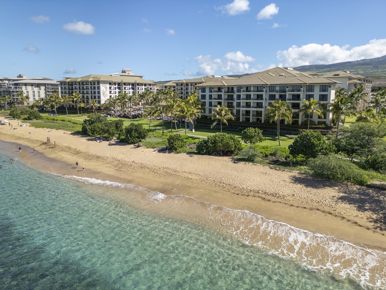 The Westin Nanea Ocean Villas along a sandy beach.